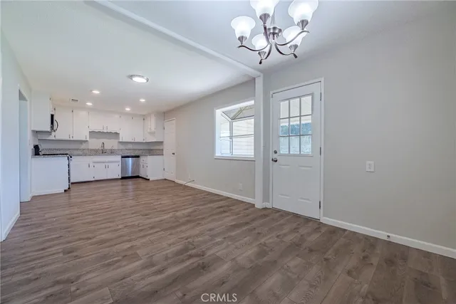 a view of a kitchen with a stove cabinets and wooden floor