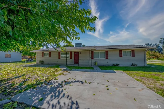 a front view of a house with a yard and a garage