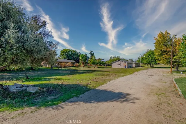 a view of a house with a swimming pool and a yard