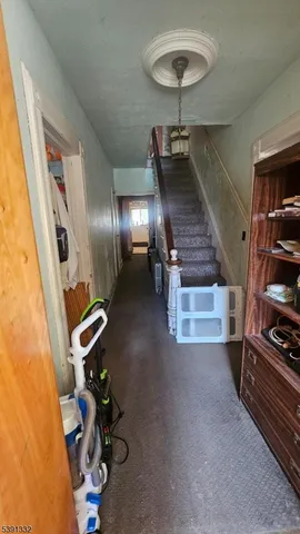a room with gym equipment and wooden floor