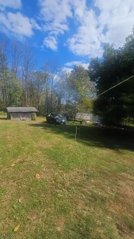 a view of a park with iron fence