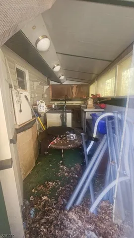 a room with a bed and a view of kitchen