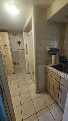 a bathroom with a sink a toilet and a shower