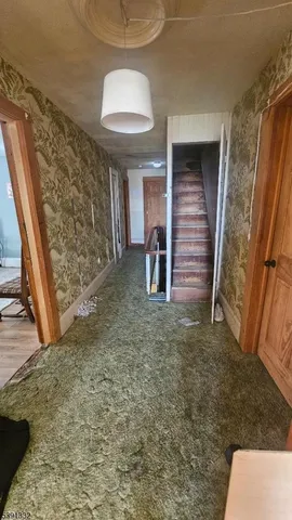 a view of room with wooden floor and furniture