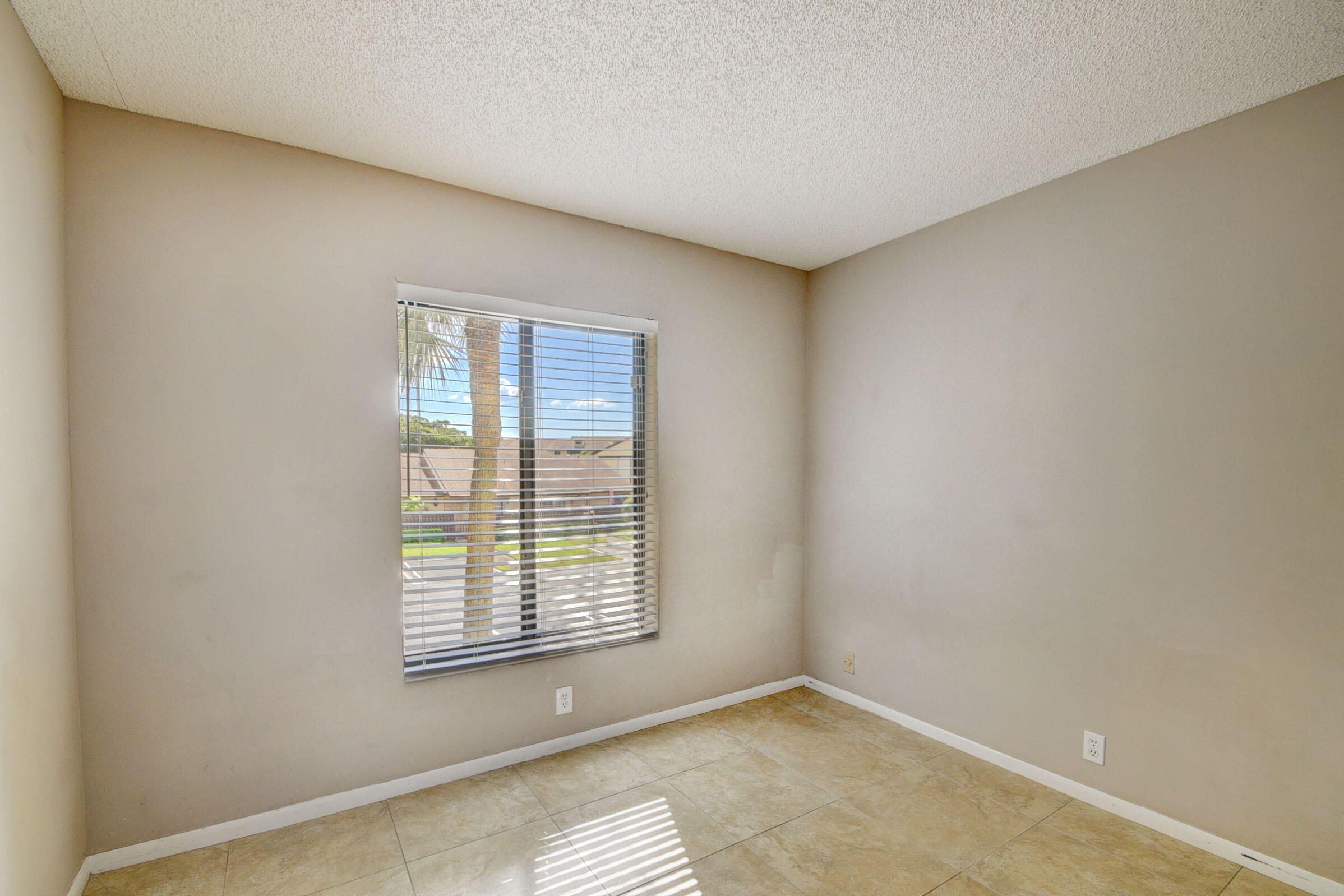 802 Sky Pine Way, Unit C2 Greenacres, FL 33415 - Photo 22 of 28 a view of an empty room with a window
