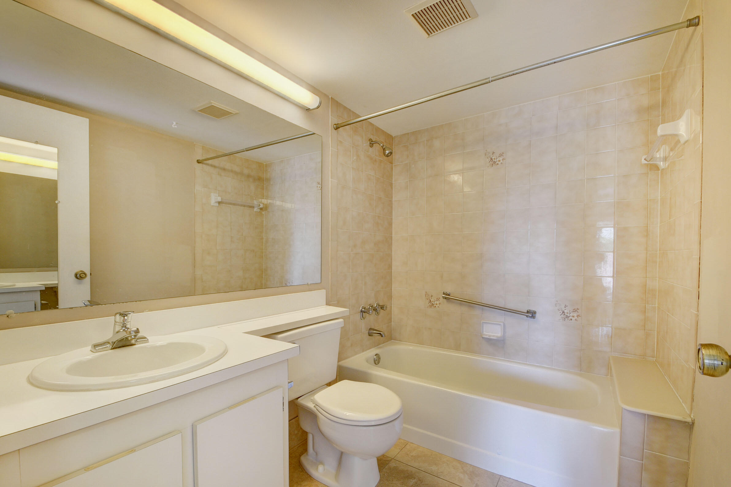 802 Sky Pine Way, Unit C2 Greenacres, FL 33415 - Photo 24 of 28 a bathroom with a sink toilet a mirror and shower