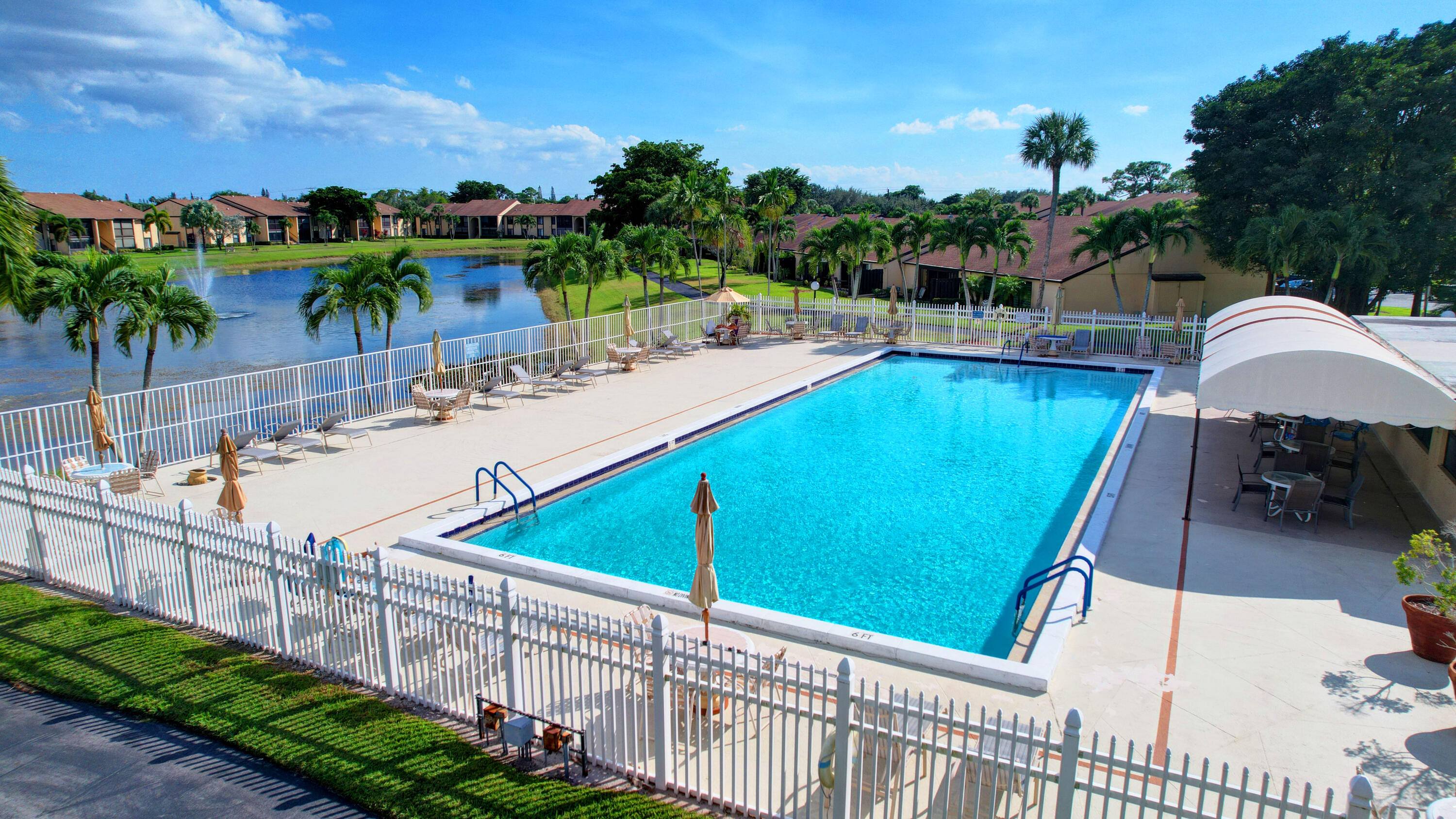 802 Sky Pine Way, Unit C2 Greenacres, FL 33415 - Photo 26 of 28 a view of a swimming pool with a patio