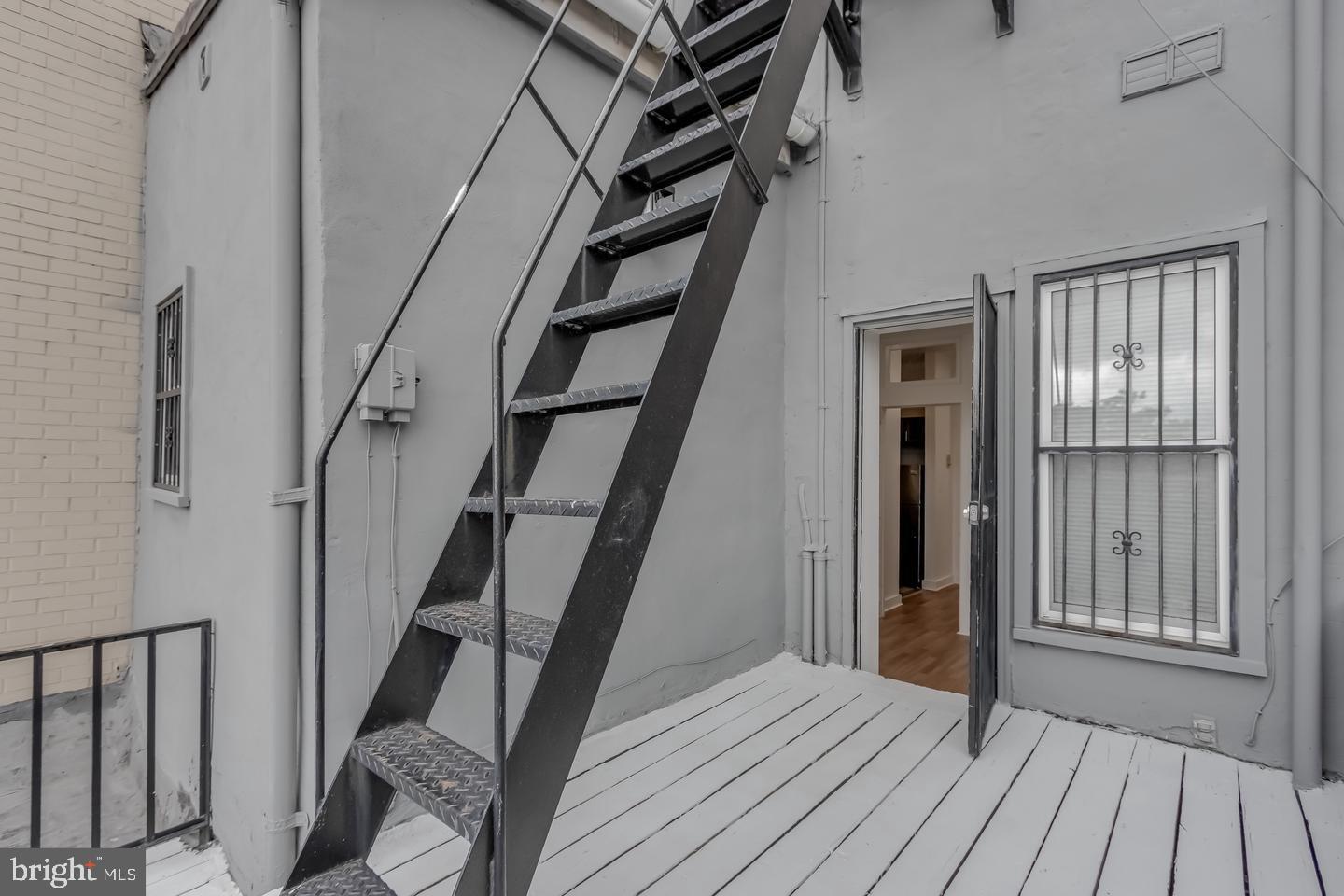 1113 North Calvert Street Baltimore, MD 21202 - Photo 11 of 25 wooden floor to ceiling window and stairs