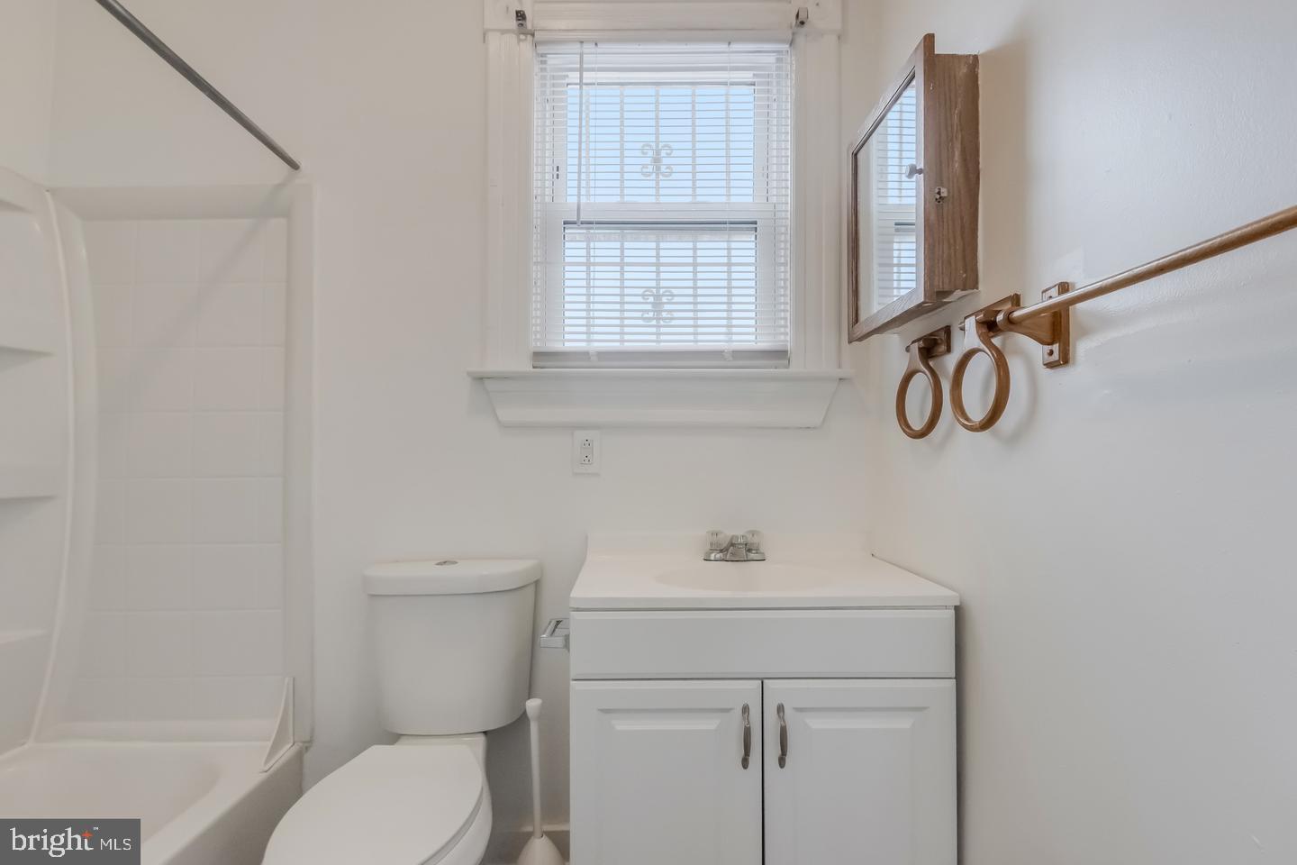 1113 North Calvert Street Baltimore, MD 21202 - Photo 15 of 25 a bathroom with a toilet sink vanity and mirror