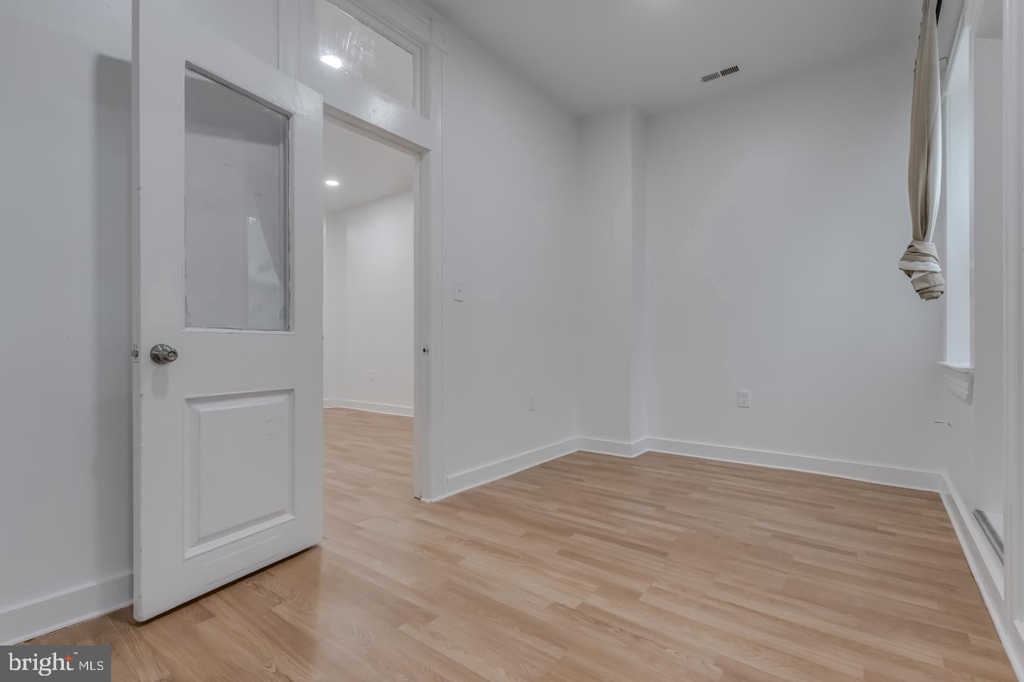 1113 North Calvert Street Baltimore, MD 21202 - Photo 16 of 25 wooden floor in an empty room