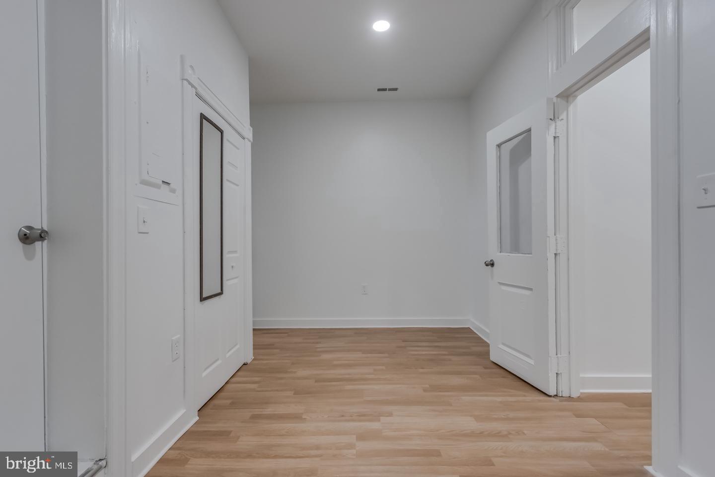 1113 North Calvert Street Baltimore, MD 21202 - Photo 17 of 25 a view of a hallway with wooden floor
