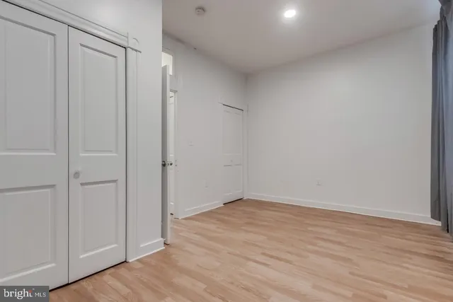a view of a room with wooden floor