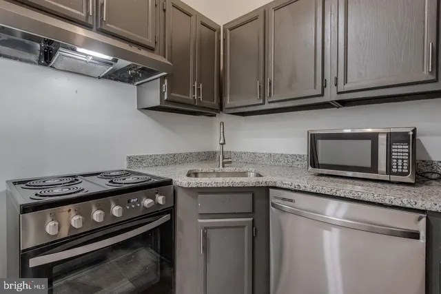 a kitchen with a sink stove and refrigerator