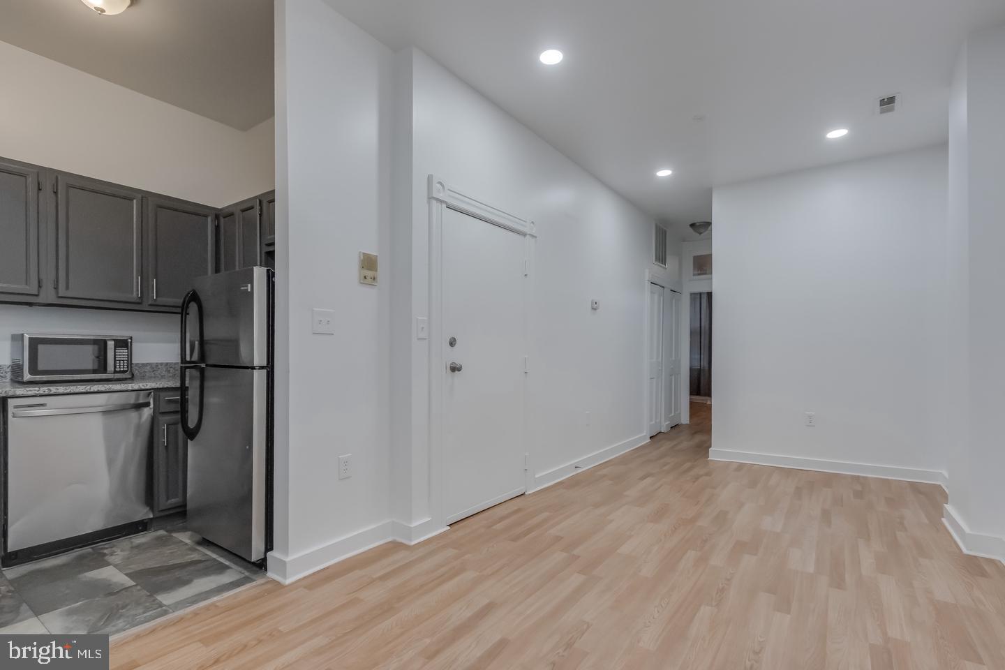 1113 North Calvert Street Baltimore, MD 21202 - Photo 9 of 25 a view of a kitchen with a sink and a refrigerator