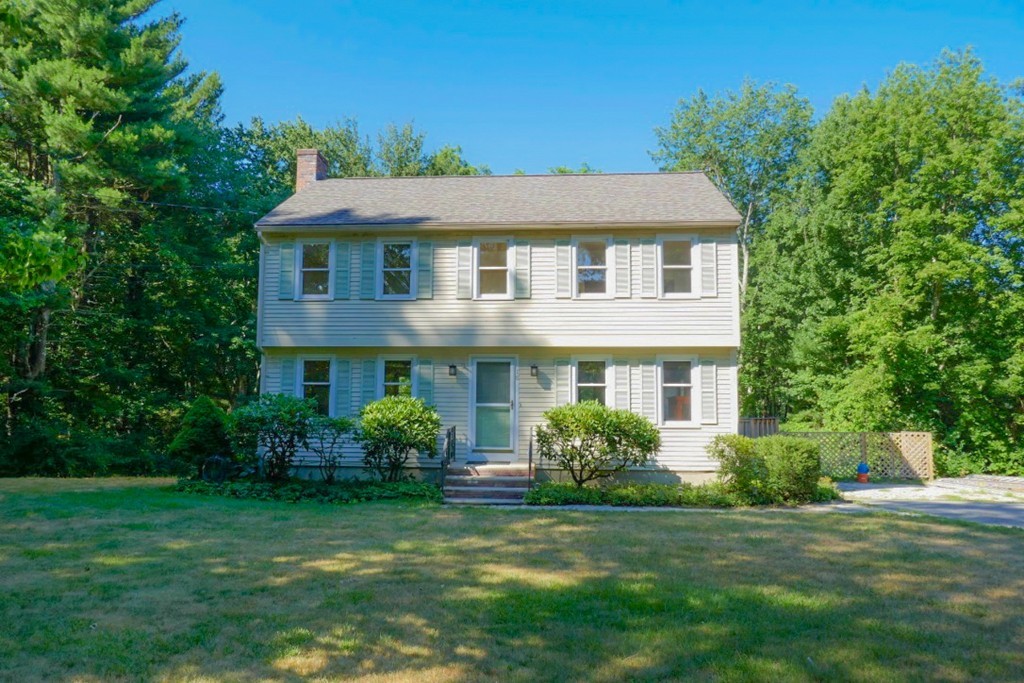 18 Line Road Westford, MA 01886 - Photo 1 of 12 a front view of a house with a garden