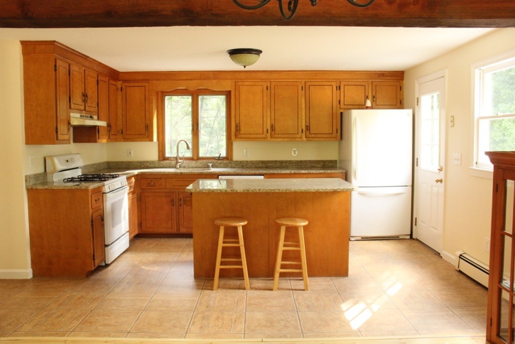 18 Line Road Westford, MA 01886 - Photo 2 of 12 a kitchen with a stove a refrigerator and a sink