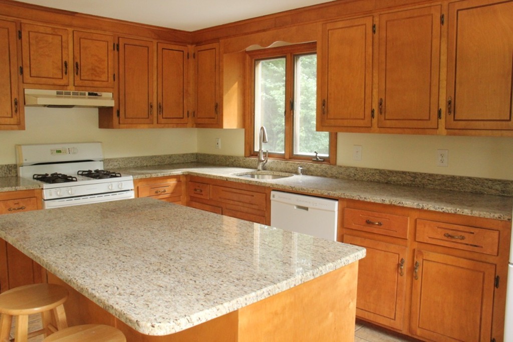 18 Line Road Westford, MA 01886 - Photo 3 of 12 a kitchen with granite countertop a sink a stove and cabinets
