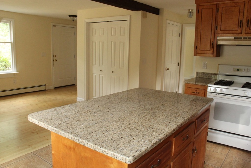 18 Line Road Westford, MA 01886 - Photo 8 of 12 a kitchen with stainless steel appliances granite countertop wooden cabinets and sink