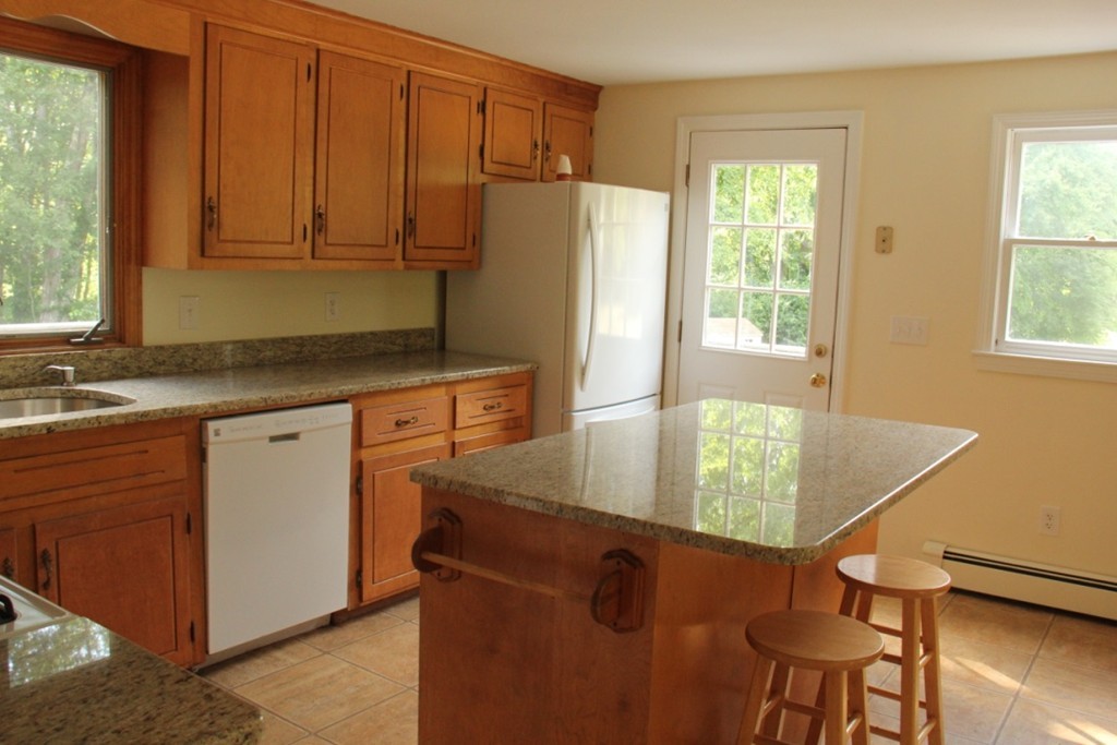 18 Line Road Westford, MA 01886 - Photo 9 of 12 a kitchen with stainless steel appliances granite countertop a refrigerator sink and cabinets