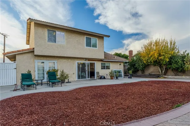 a front view of a house with a yard and trees