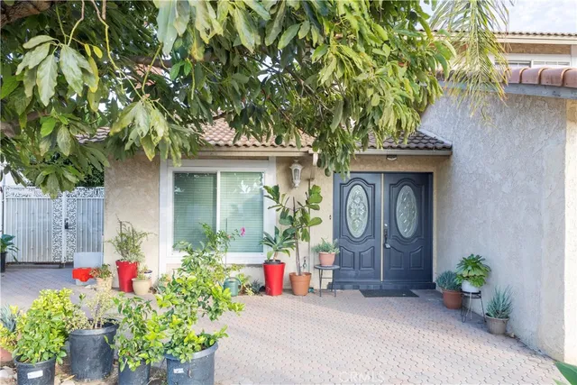 a front view of a house with potted plants