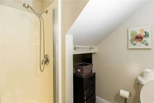 a bathroom with a toilet and a shower