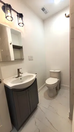 a bathroom with a sink toilet and mirror