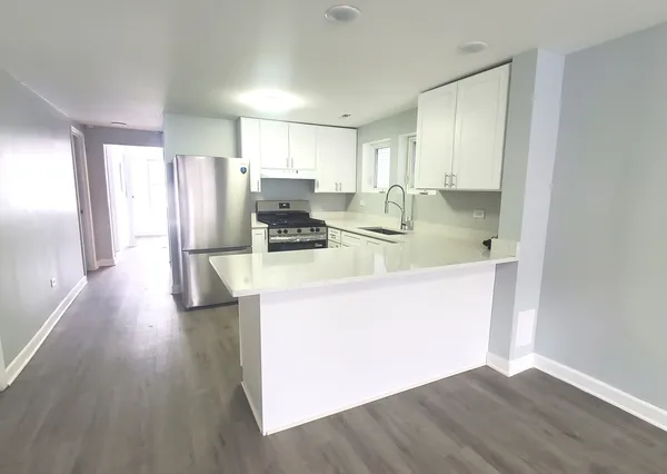 a kitchen with stainless steel appliances a refrigerator and a stove top oven