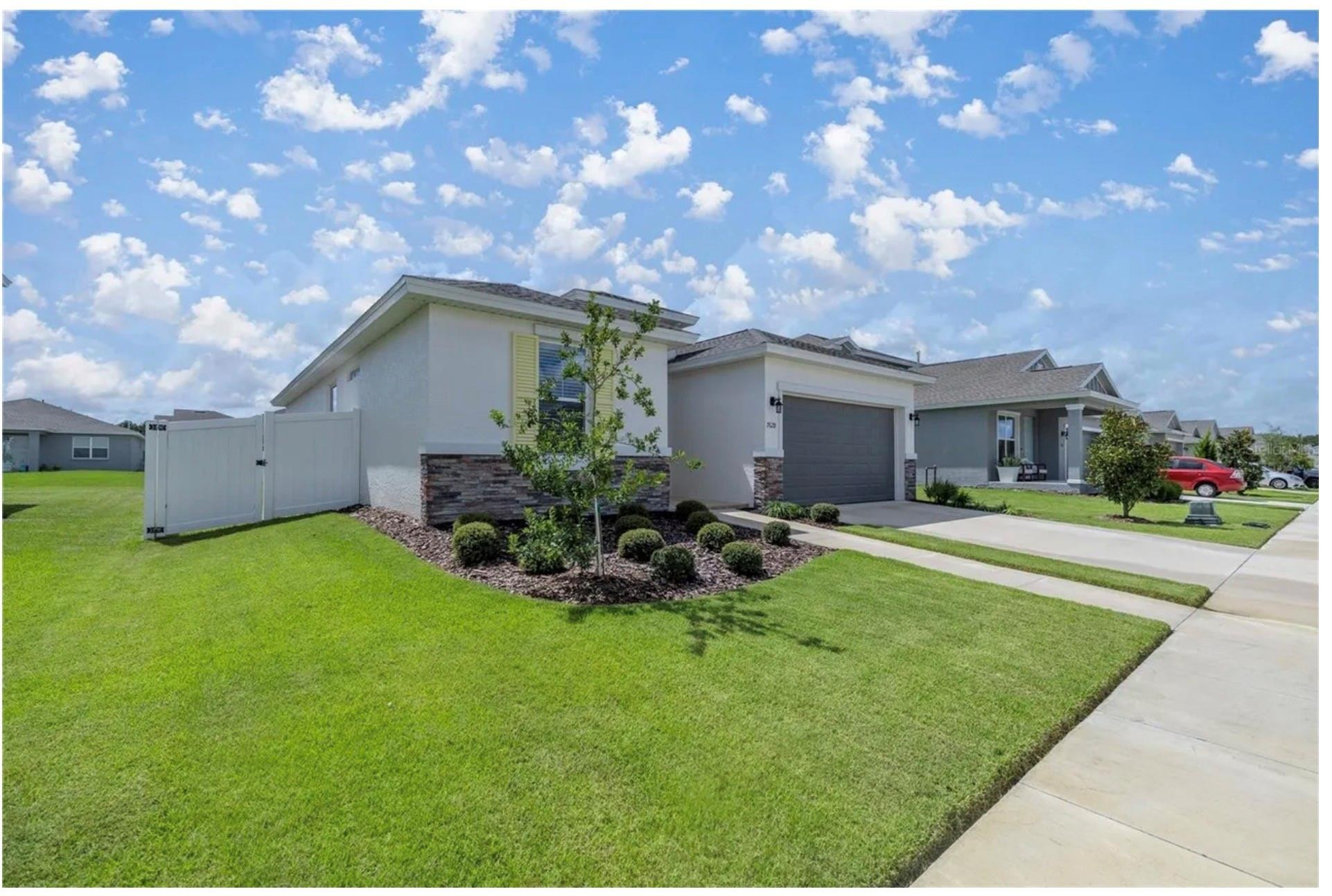 7628 Southwest 63rd Lane Road Ocala, FL 34474 - Photo 1 of 25 a view of a house with backyard sitting area and garden