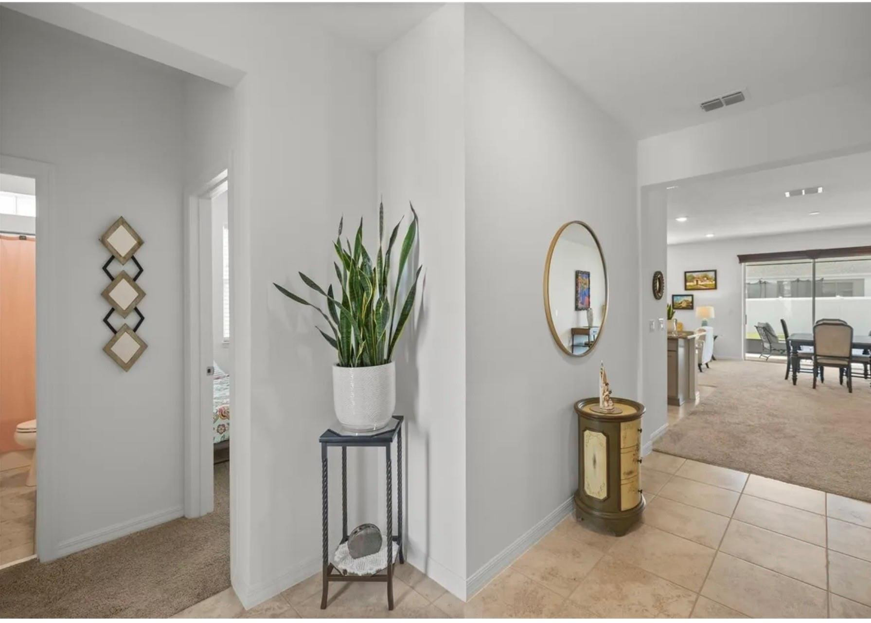 7628 Southwest 63rd Lane Road Ocala, FL 34474 - Photo 5 of 25 a living room with furniture a clock and a potted plant