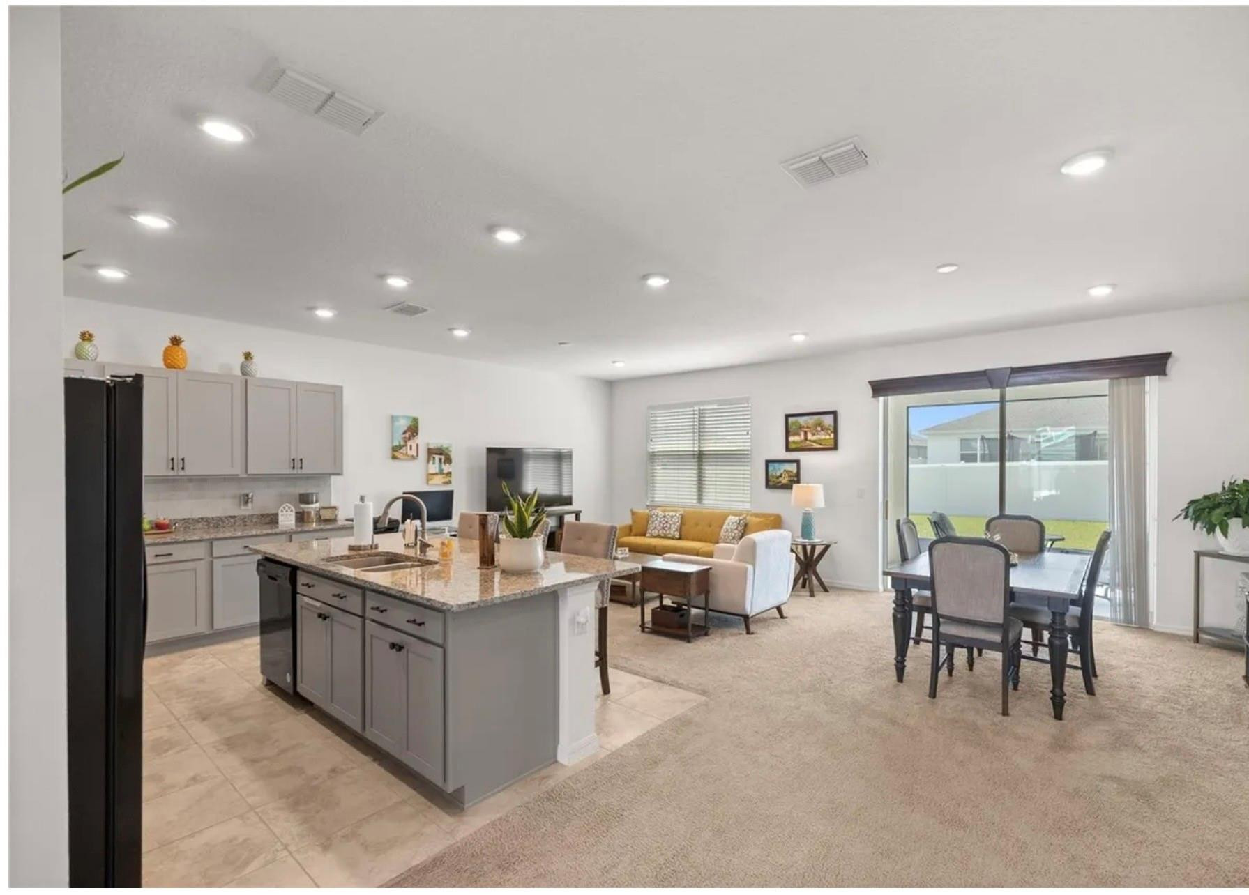 7628 Southwest 63rd Lane Road Ocala, FL 34474 - Photo 6 of 25 a living room with stainless steel appliances kitchen island granite countertop furniture a sink a counter top and stainless steel appliances