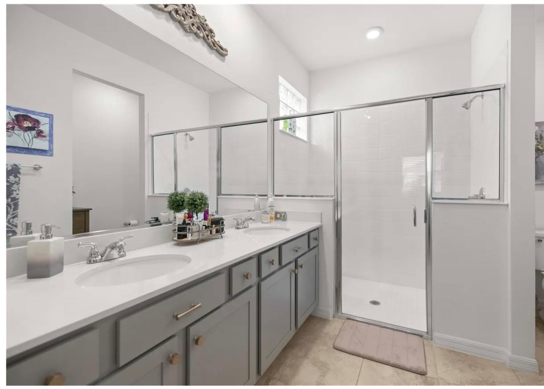 7628 Southwest 63rd Lane Road Ocala, FL 34474 - Photo 10 of 25 a bathroom with a double vanity sink and mirror