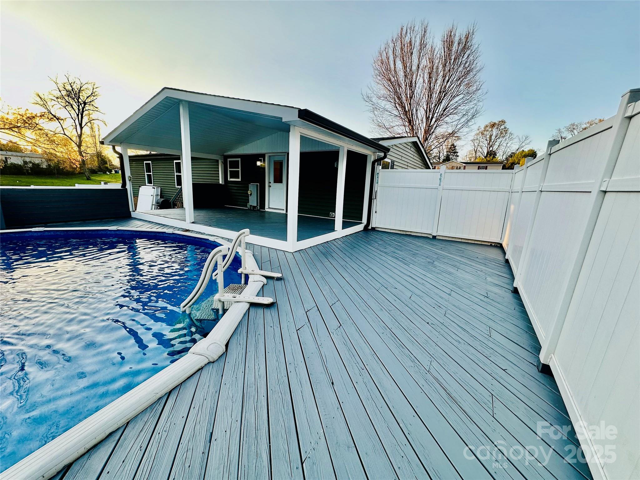 swimming pool view with a seating space
