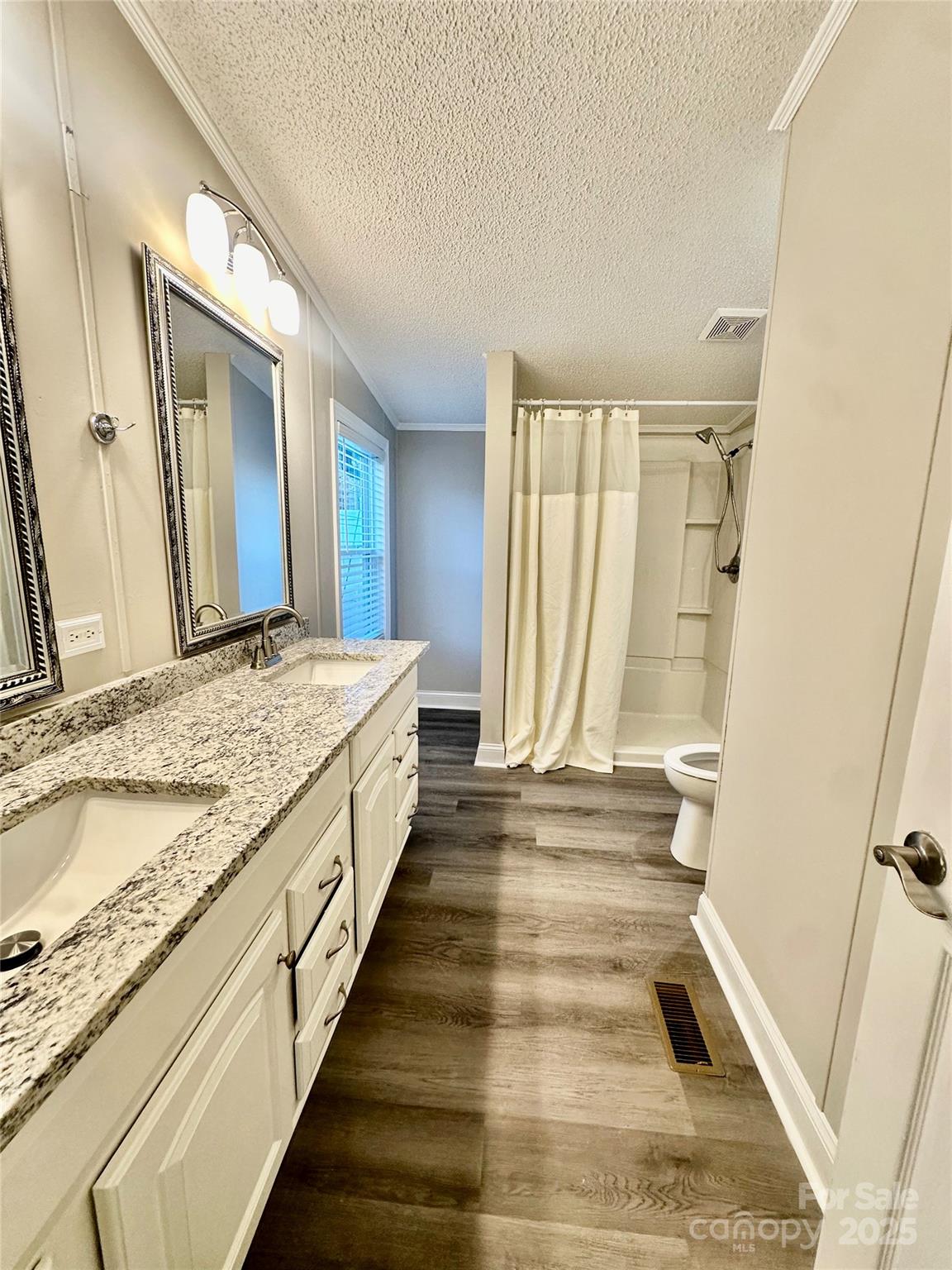 980 Olde Creek Trail Concord, NC 28025 - Photo 17 of 26 a bathroom with a granite countertop sink and a mirror