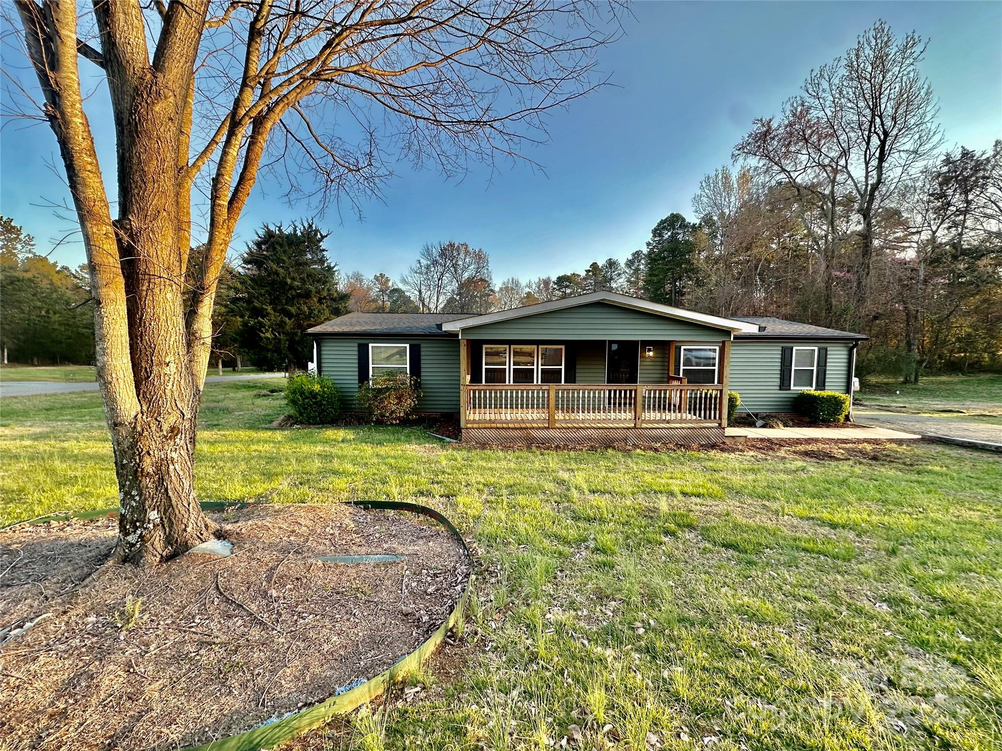 980 Olde Creek Trail Concord, NC 28025 - Photo 2 of 26 a front view of a house with a yard table and chairs