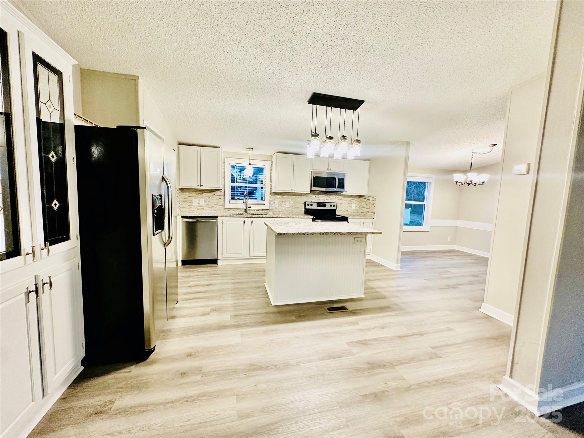 980 Olde Creek Trail Concord, NC 28025 - Photo 8 of 26 a kitchen with stainless steel appliances a refrigerator and a sink