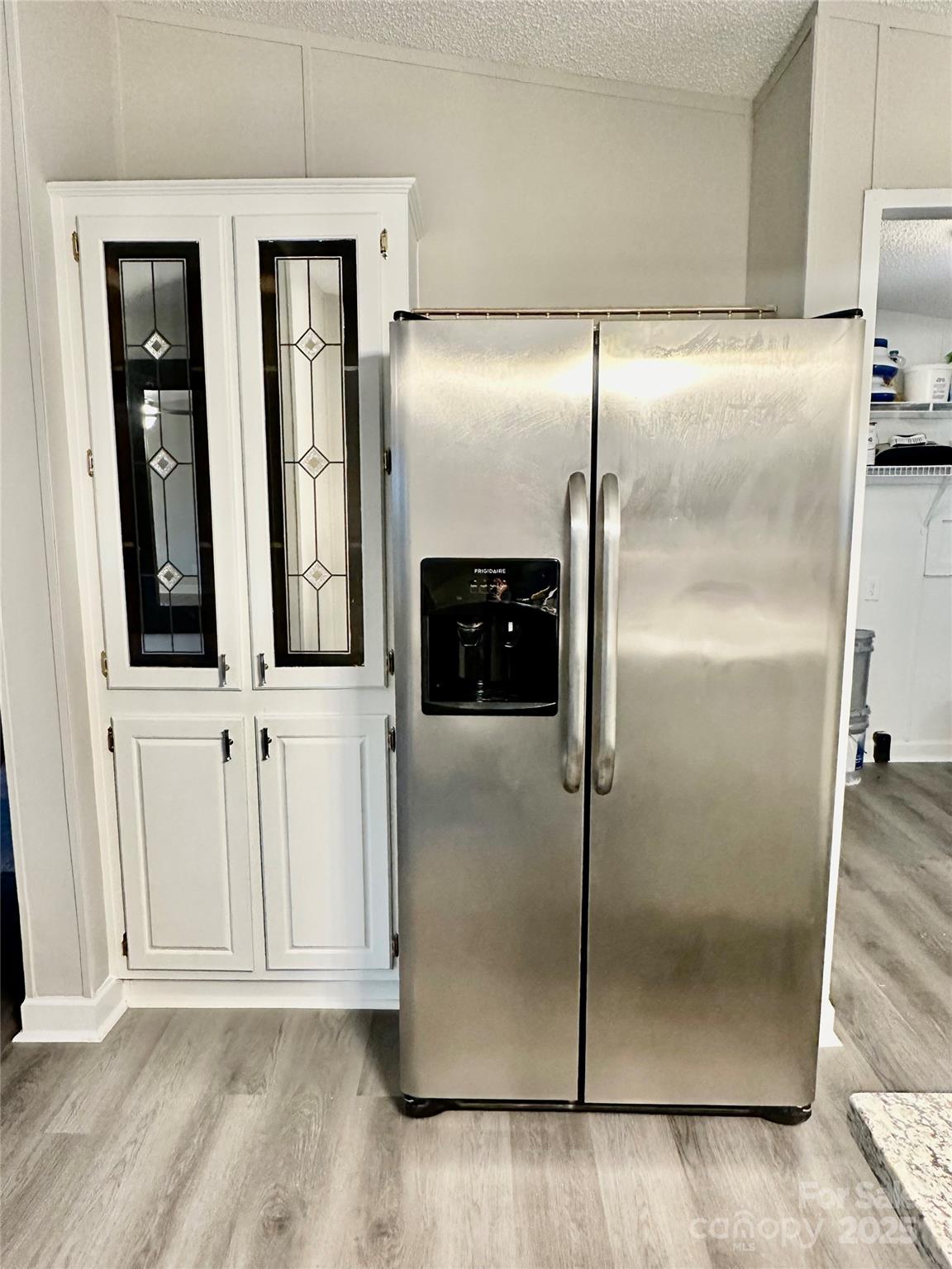 980 Olde Creek Trail Concord, NC 28025 - Photo 10 of 26 a empty room with wooden floor and cabinet