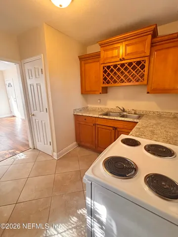 a kitchen with a sink a stove and cabinets