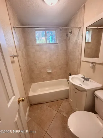 a bathroom with a sink a toilet and a bathtub