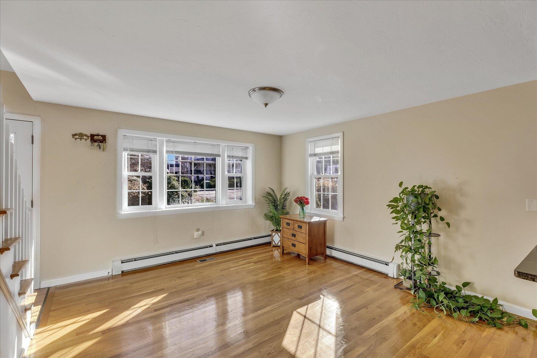 53 Deer Ridge Road Mashpee, MA 02649 - Photo 16 of 50 a living room with furniture floor to ceiling window and potted plant