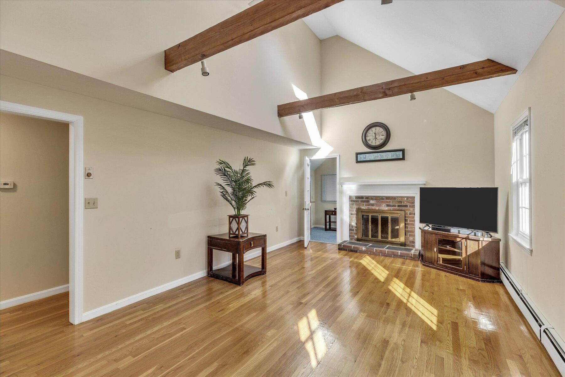 53 Deer Ridge Road Mashpee, MA 02649 - Photo 2 of 50 a living room with furniture and a fireplace