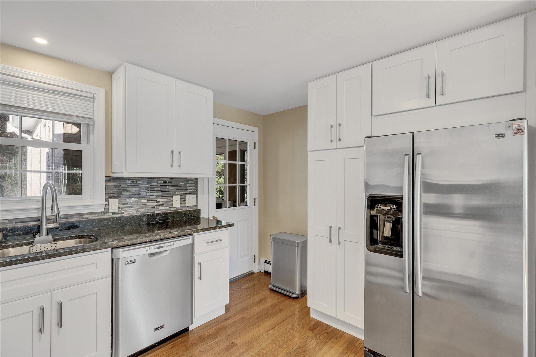53 Deer Ridge Road Mashpee, MA 02649 - Photo 22 of 50 a kitchen with white cabinets and refrigerator