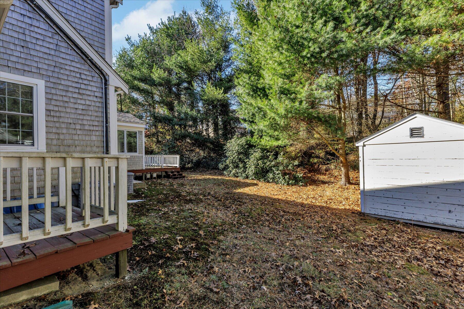 53 Deer Ridge Road Mashpee, MA 02649 - Photo 46 of 50 a view of a small yard and wooden fence