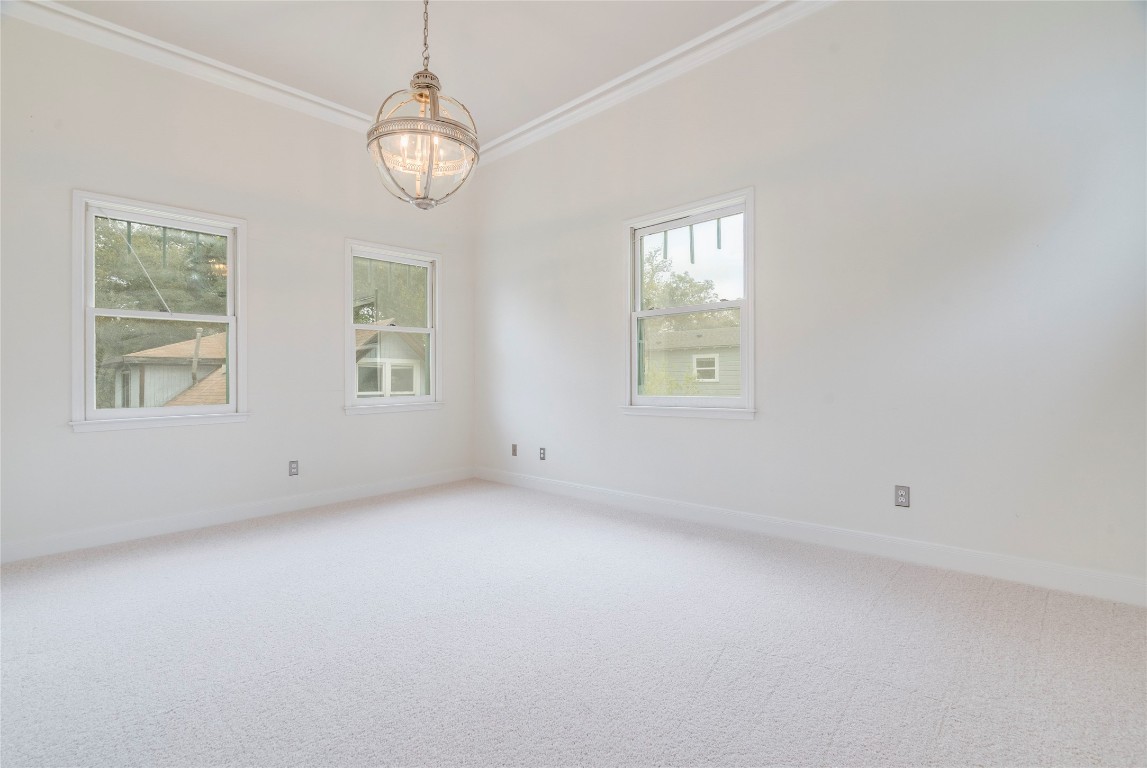 512 East 49th Street, Unit A Austin, TX 78751 - Photo 11 of 31 an empty room with windows and chandelier fan