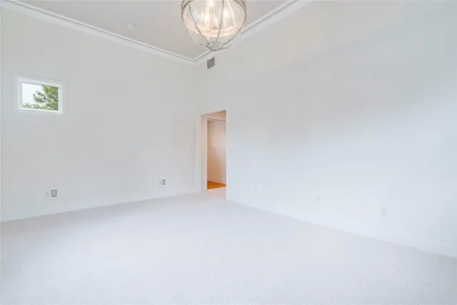 an empty room with a chandelier fan