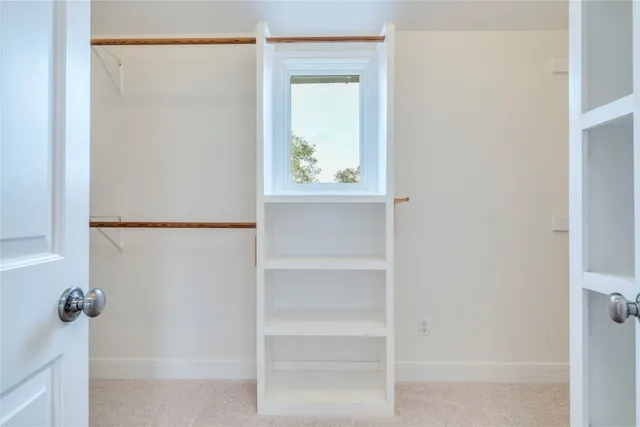 a view of hallway with closet