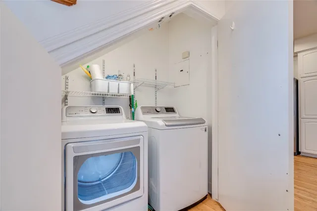 a view of washer and dryer with kitchen in the background