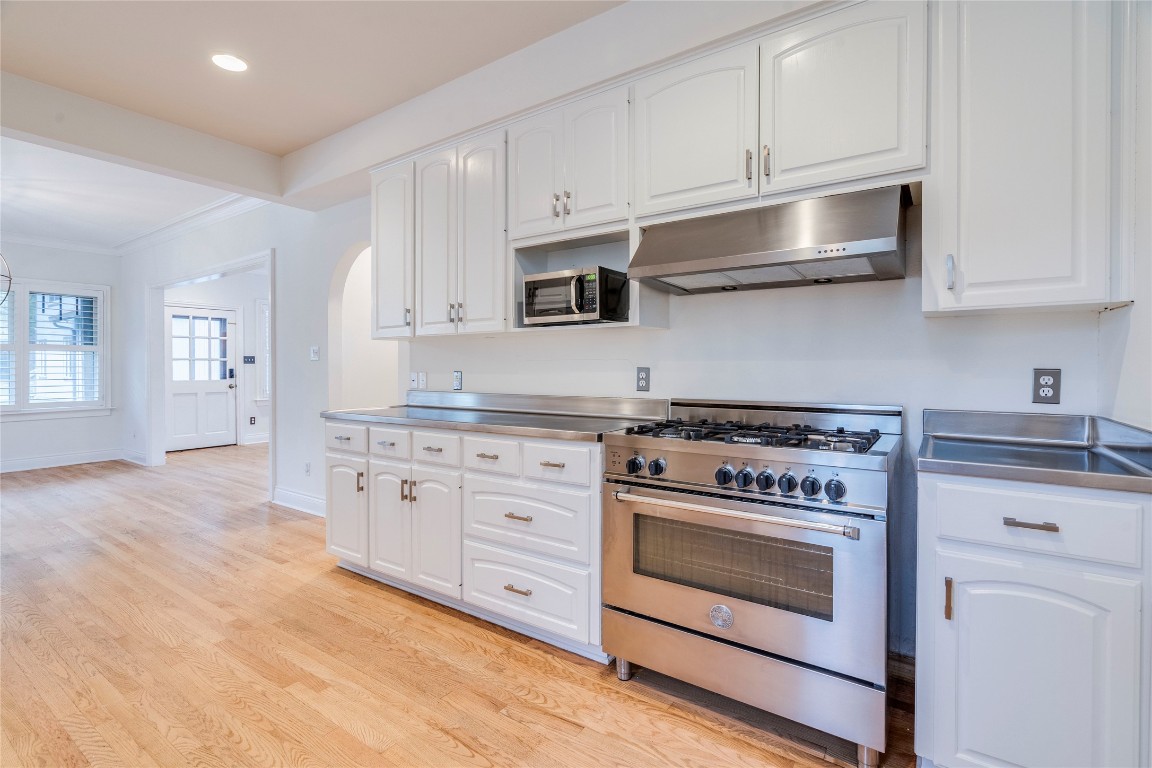 512 East 49th Street, Unit A Austin, TX 78751 - Photo 2 of 31 a kitchen with granite countertop white cabinets and stainless steel appliances