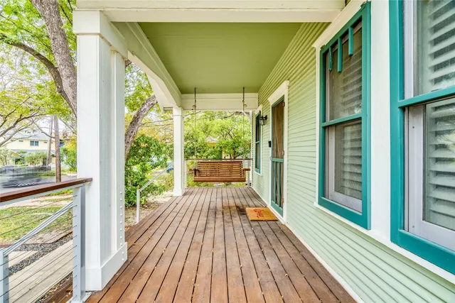 a view of balcony with wooden floor