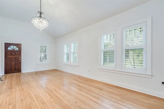 a view of a livingroom with a window and wooden floor